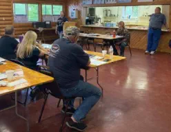 Instructor Amy Glasheen provides instruction while Instructors Colt Glasheen and Anthony Erickson look on.